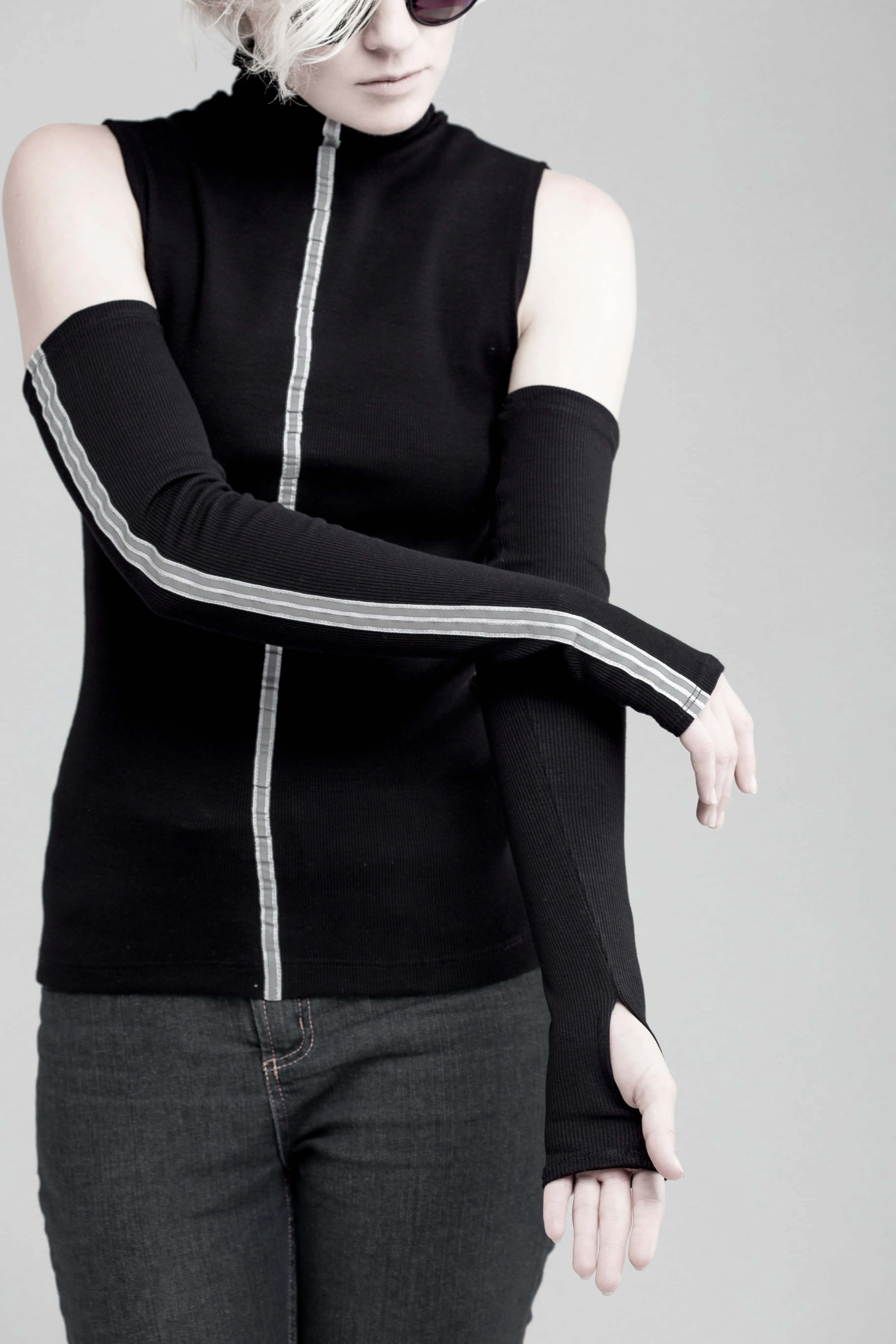 Black sleeveless turtleneck top with long fingerless gloves