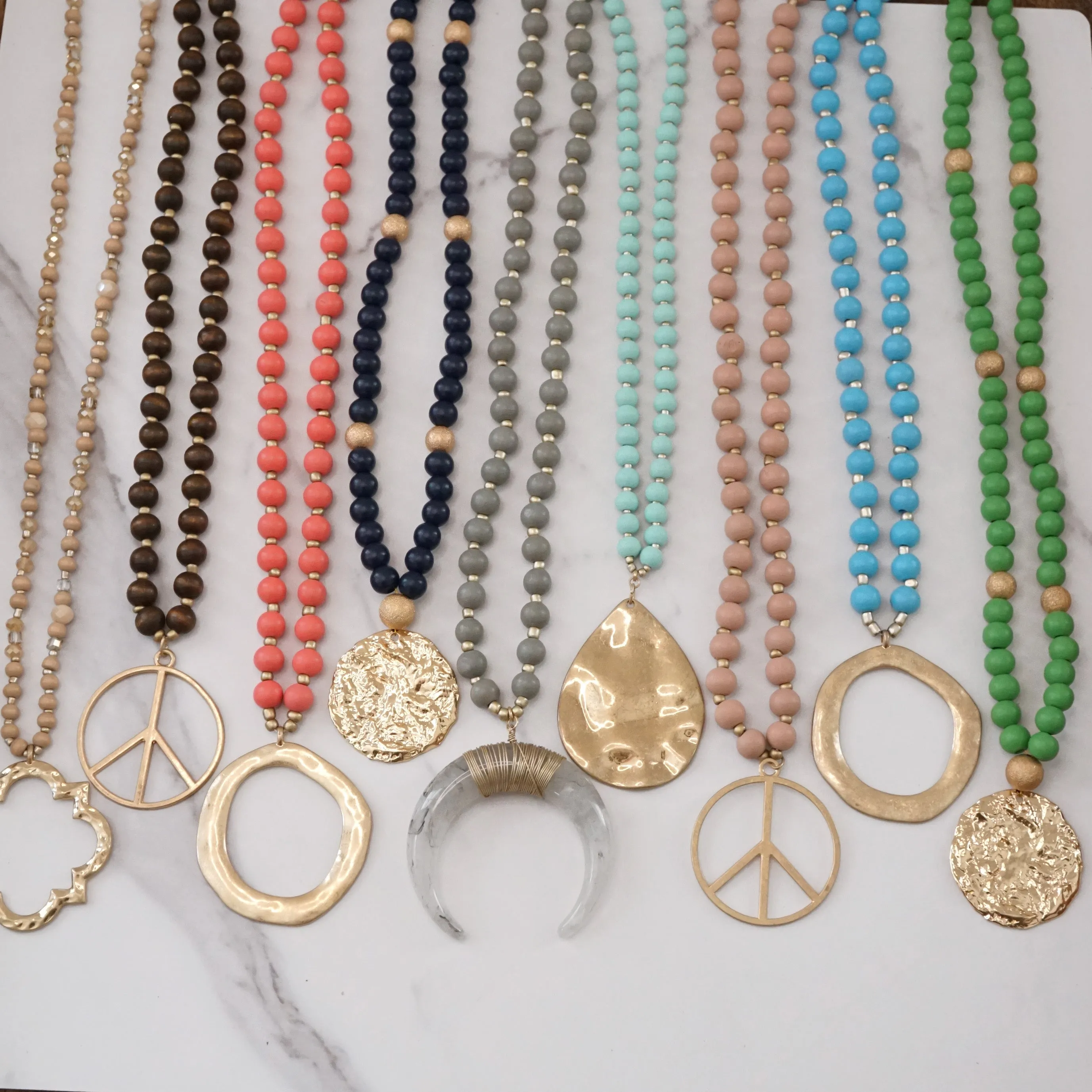 Long Wood Bead Necklace with golden peace sign pendant - Pink