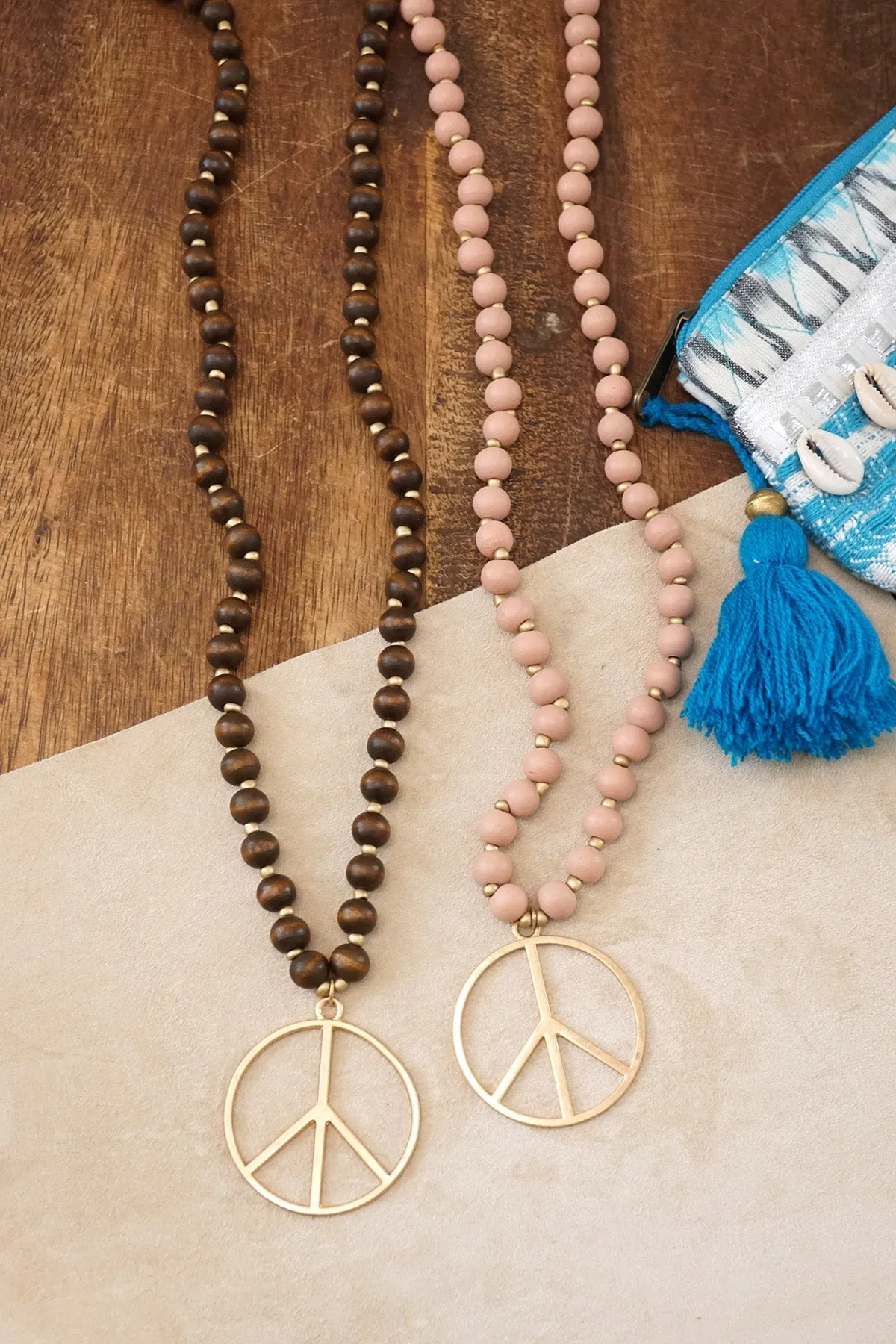 Long Wood Bead Necklace with golden peace sign pendant - Pink