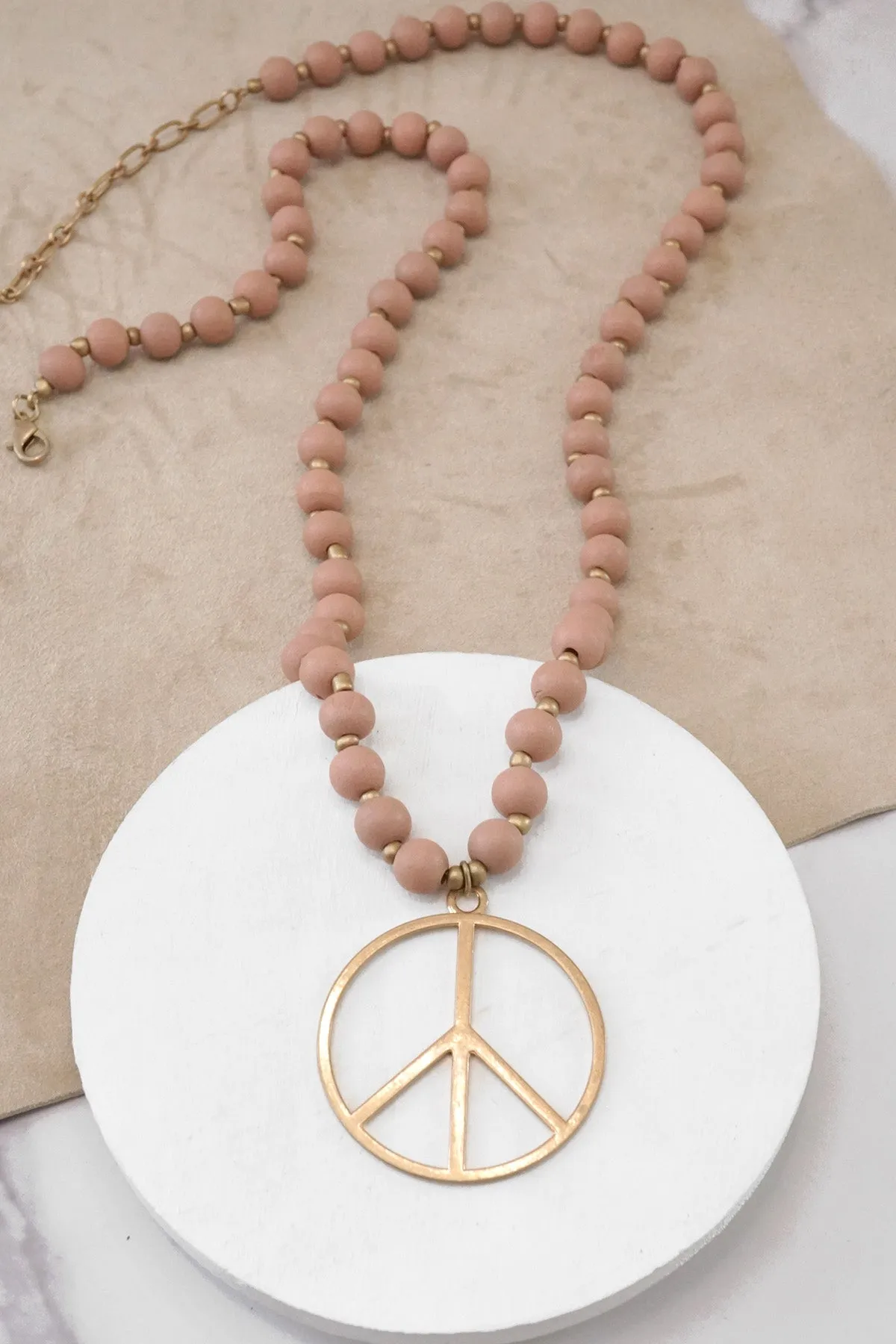 Long Wood Bead Necklace with golden peace sign pendant - Pink