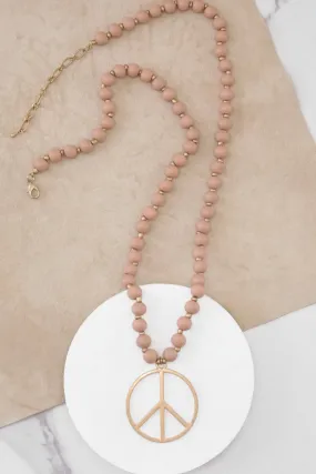 Long Wood Bead Necklace with golden peace sign pendant - Pink