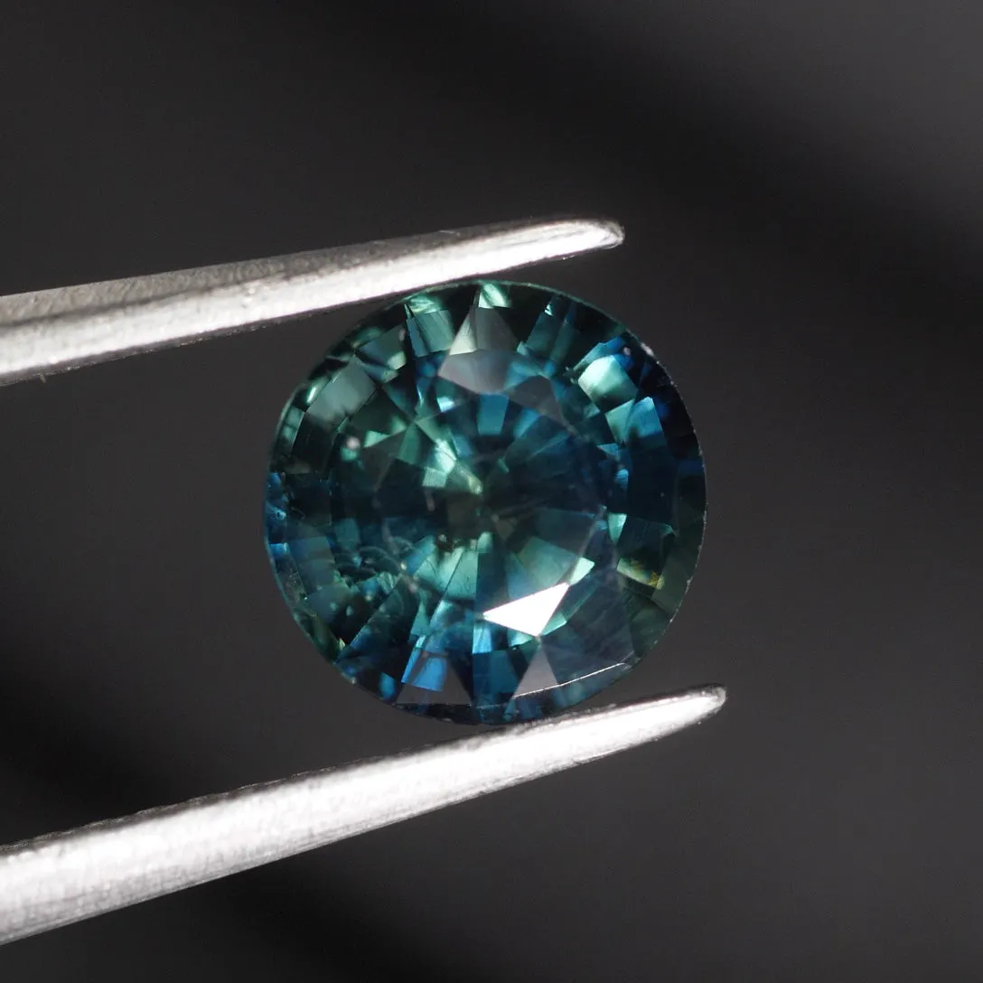 Sapphire Teal | IGI certified | natural, bluish green, color-changing, round cut 6.5* mm, 1.48ct